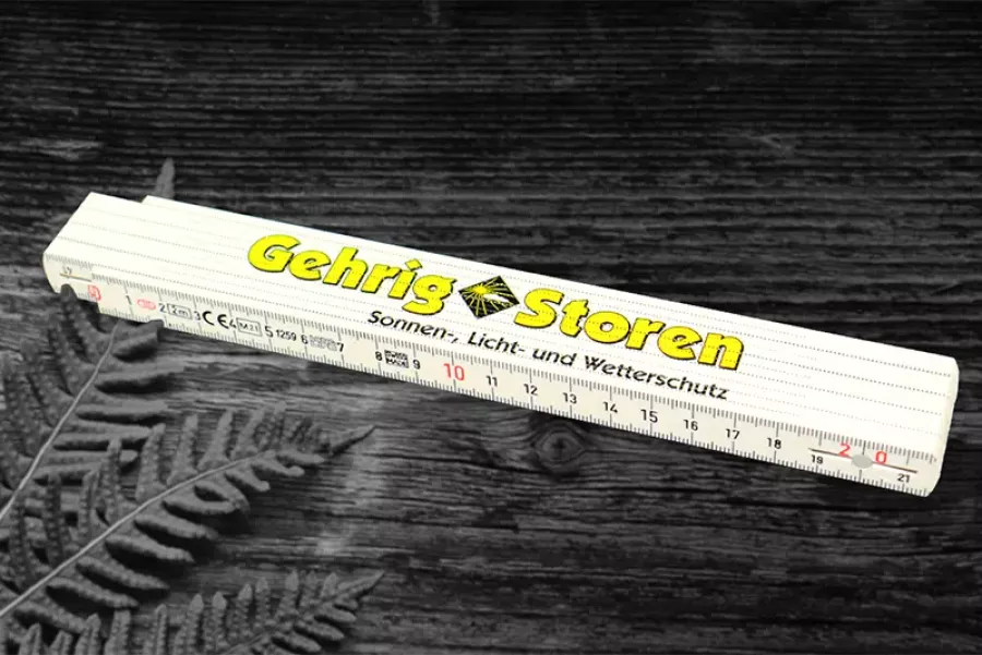 Werbeartikel Give-Aways Kunststoffmeter Gehrig Storen SICHTBAR Beschriftung Belp